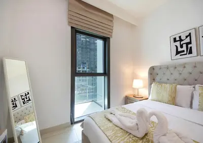 a bedroom with a bed with two swans on it at Upscale2BR in Burj Crown Pool,Gym & Stunning Views in Dubai