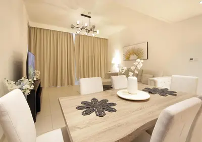 a dining table with white chairs and a dining room at Upscale2BR in Burj Crown Pool,Gym & Stunning Views in Dubai