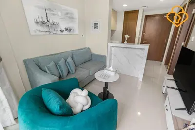 a living room with a blue couch and a television at Keysplease 1 BR Apt, Vera Residence Business Bay in Dubai