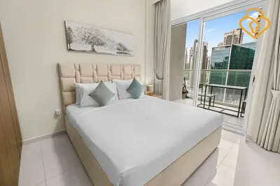 a white bedroom with a large bed and a window at Keysplease 1 BR Apt, Vera Residence Business Bay in Dubai
