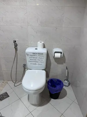 a bathroom with a toilet and a shower in it at Large 1BR Apartment with Balcony in JVC - JLiving in Dubai