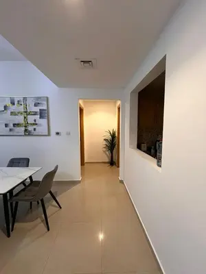 a hallway with a table and a dining room at Large 1BR Apartment with Balcony in JVC - JLiving in Dubai