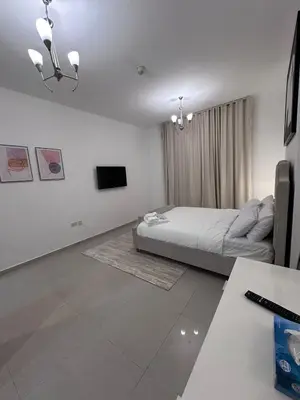 a bedroom with a bed and a television in it at Large 1BR Apartment with Balcony in JVC - JLiving in Dubai