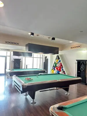 a room with two pool tables and a rack of balls at Souk Al Bahar Luxury stays near poolside with Burj Khalifa view by Norbu Holiday Homes in Dubai