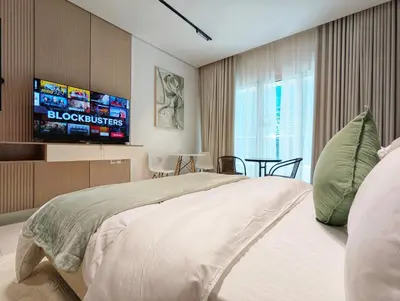 a bedroom with a large bed and a tv at Waterfront Studio with Burj Khalifa & Dubai Mall Access, Walk to Dubai Water Canal & Business Bay Metro in Dubai