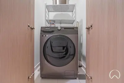 a washing machine in a room with two doors at Luxurious 4BR In Act 1 Act 2 With Burj Khalifa View in Dubai