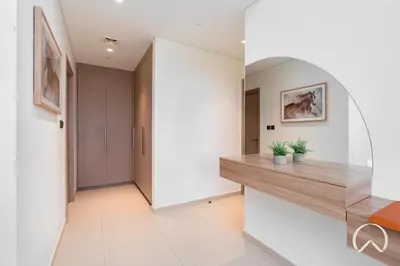 a hallway with a wooden counter in a house at Luxurious 4BR In Act 1 Act 2 With Burj Khalifa View in Dubai