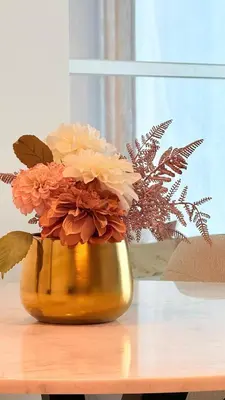 a vase filled with flowers sitting on a table at Brand New Golf View - Luxe Nest at Dubai Hills one bedroom apartment in Dubai