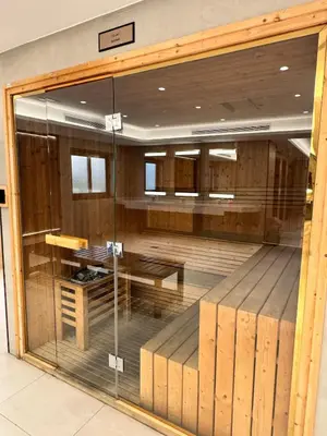 a glass window in a room with a table and bench at Burj Khalifa View from your Balcony in Dubai
