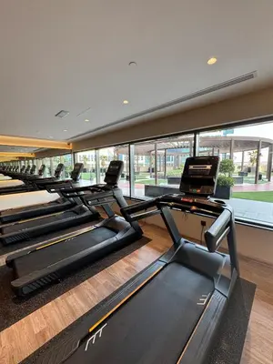a gym with a row of treadmills at Burj Khalifa View from your Balcony in Dubai