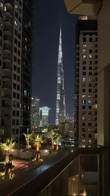 a view of a city skyline at night at Burj Khalifa View from your Balcony in Dubai