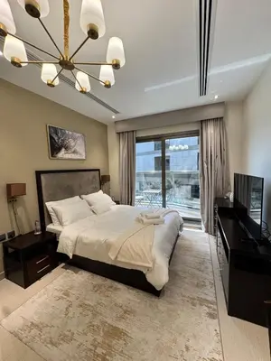 a bedroom with a large bed and a television at Burj Khalifa View from your Balcony in Dubai