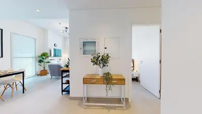 a living room with a table and a dining room at Tranquil Oasis 2BR at Collective Dubai Hills in Dubai