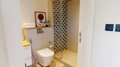 a bathroom with a toilet and a shower at Tranquil Oasis 2BR at Collective Dubai Hills in Dubai