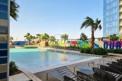 a pool at a resort with chairs and a building at Close to Dubai Water Canal 1BR with Balcony, Aykon City 2 Tower C, Business Bay by Deluxe Holiday Homes in Dubai