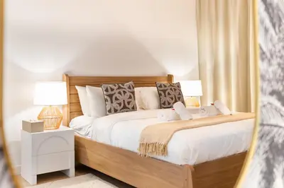a bedroom with a large bed with two lamps at BURJ views Private Beach 2 Bedroom Apartment with panoramic Sea View and Pool Palm Jumeirah in Dubai