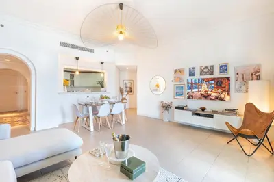 a living room with a couch and a table at BURJ views Private Beach 2 Bedroom Apartment with panoramic Sea View and Pool Palm Jumeirah in Dubai