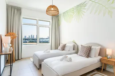 a hotel room with two beds and a window at BURJ views Private Beach 2 Bedroom Apartment with panoramic Sea View and Pool Palm Jumeirah in Dubai