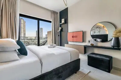 a bedroom with a large bed and a large window at GuestReady - Modern living in JVC in Dubai