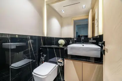 a bathroom with a sink and a toilet and a mirror at GuestReady - Modern living in JVC in Dubai