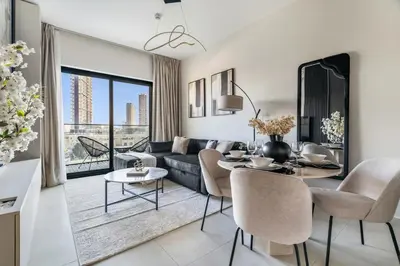 a living room with a couch and a table at GuestReady - Modern living in JVC in Dubai
