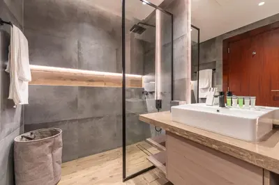 a bathroom with a sink and a shower at HAVN - Modern Studio in JVC with Huge Layout in Dubai