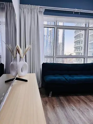 a living room with a couch and a table at ZenStay-Stylish Studio 1 Min to Metro in JLT in Dubai