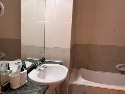 a bathroom with a sink and a bath tub at ZenStay-Stylish Studio 1 Min to Metro in JLT in Dubai