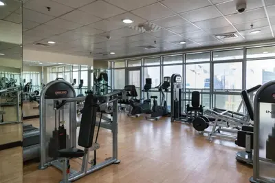 a gym with treadmills and cardio equipment in a building at ZenStay-Stylish Studio 1 Min to Metro in JLT in Dubai