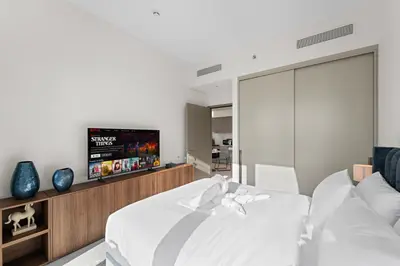 a bedroom with a bed and a flat screen tv at Luxury 1BR in Downtown l Close to Dubai Mall in Dubai