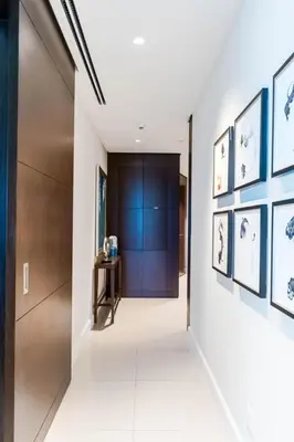 a hallway with pictures on the walls of a building at The ME Apartment in Dubai
