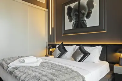 a hotel room with a bed with a picture on the wall at Luxury 1-Bedroom, High-Floor, Skyline Views in Dubai