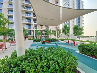 a playground in the courtyard of a building with a building at Marina Vista - Airy One Bedroom in Dubai Marina in Dubai