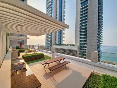 a balcony with benches and a view of the ocean at Marina Vista - Airy One Bedroom in Dubai Marina in Dubai