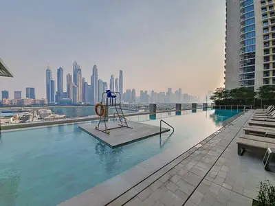 a swimming pool with a statue in the middle of a city at Marina Vista - Airy One Bedroom in Dubai Marina in Dubai