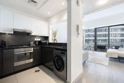 a kitchen with a stove and a washer and dryer at Waterfront Studio, perfectly located in Dubai Marina in Dubai