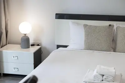 a bedroom with a bed and a lamp on a night stand at Waterfront Studio, perfectly located in Dubai Marina in Dubai