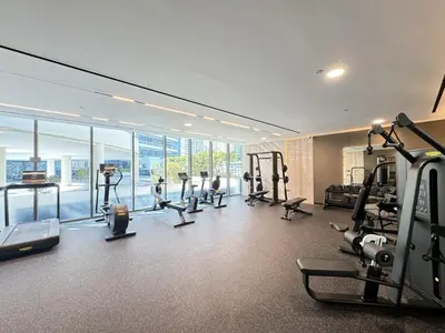 a gym with treadmills and ellipticals in a building at Waterfront Studio, perfectly located in Dubai Marina in Dubai