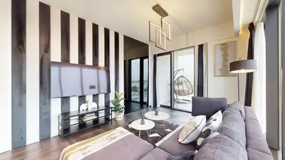 a living room with a couch and a table at O Ten - Classy One Bedroom in Al Jaddaf in Dubai
