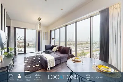 a living room with a couch and a table at O Ten - Classy One Bedroom in Al Jaddaf in Dubai