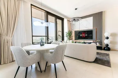 a living room with a white table and chairs at Luxurious Furnishing Direct Access to Dubai Mall in Dubai