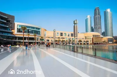 a walkway in a city with tall buildings at Luxurious Furnishing Direct Access to Dubai Mall in Dubai