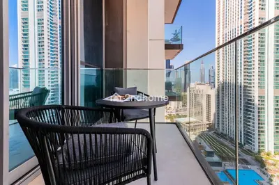 a table on a balcony with a view of the city at Luxurious Furnishing Direct Access to Dubai Mall in Dubai