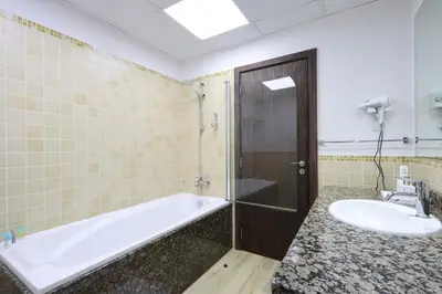a bathroom with a tub and a sink at Livbnb - Spacious 2B in Shams with Marina View Walk to Beach in Dubai