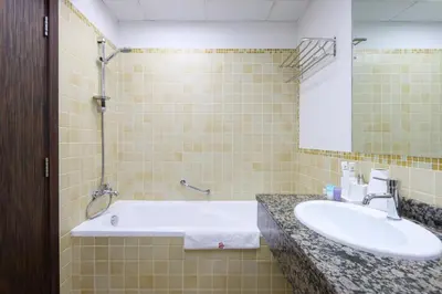 a bathroom with a sink and a bath tub at Livbnb - Spacious 2B in Shams with Marina View Walk to Beach in Dubai