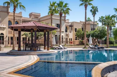 a pool at a resort with a gazebo and palm trees at Samaya Holiday Homes - Luxury Villa Pool - Beach Access & Fishing Zone in Dubai