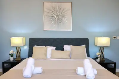 a bedroom with a large bed with white pillows at Livbnb- Coastal 2B with Marina View Walk to Beach in Dubai