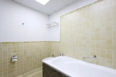 a bathroom with a tub and a mirror at Livbnb- Coastal 2B with Marina View Walk to Beach in Dubai