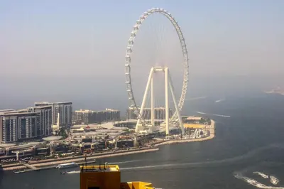 a large ferris wheel in the middle of a city at Livbnb - High Floor 2B with Marina View Walk to Beach in Dubai