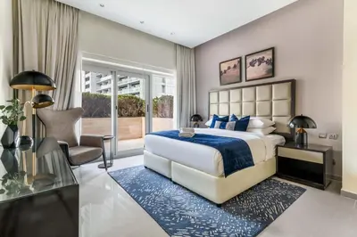 a bedroom with a large bed with a blue rug at GuestReady - Luxe Comfort in Bussiness Bay in Dubai